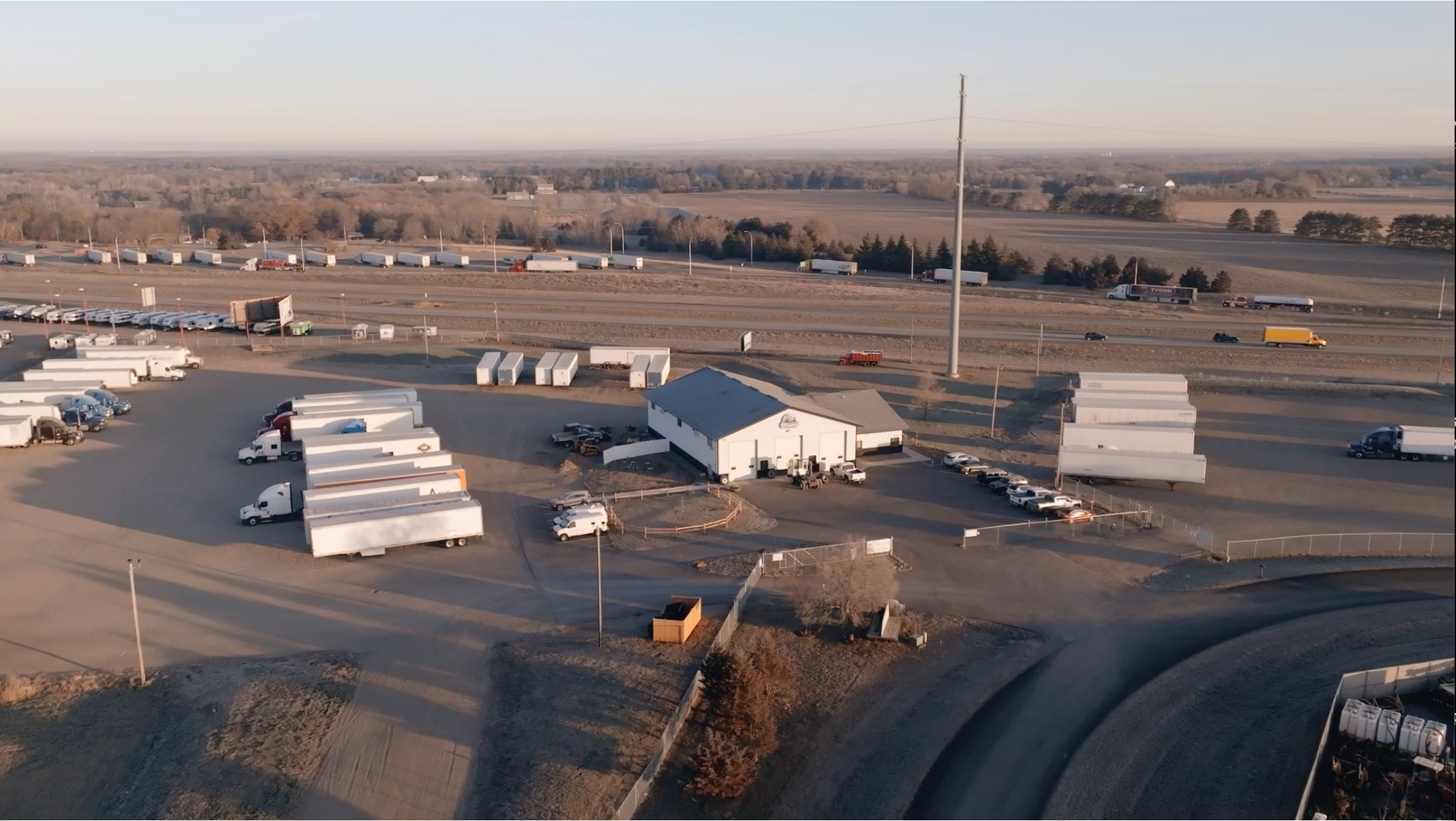 Aerial view of 94 Park Place, its parking lots and shop beside I-94 in Clearwater