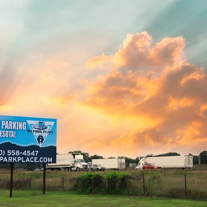 94 Park Place roadside sign and parked trailers under a sunset sky